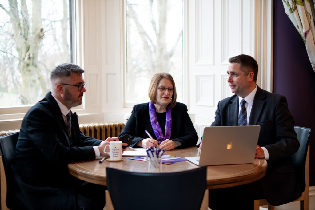 Photo of the Purves Repatriation team discussing how they can help when someone dies abroad