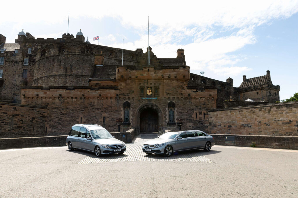 Photo of a Purves Repatriation Mercedes hearse and limousine outside the entrance to Edinburgh Castle
